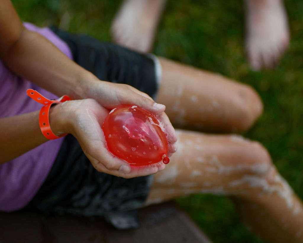 Campers at Camp CoMo Kidz cool off with water guns, water balloons, a slip n' slide and water kickball
